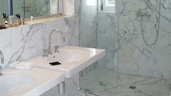 Flooring Bathroom featuring Bianco Carrara Venato Marble, highlighting its elegance and versatility.
