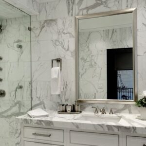 Luxurious bathroom featuring Bianco Carrara Marble walls, a popular choice in London, United Kingdom.