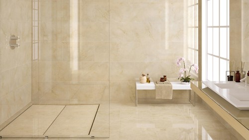 Tiles & Walls Luxurious bathroom with Crema Marfil Marble tiles in a Surrey residence.