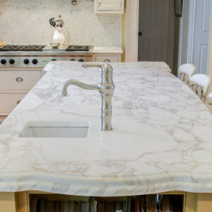 Kitchen island featuring Calacatta Oro Marble worktop