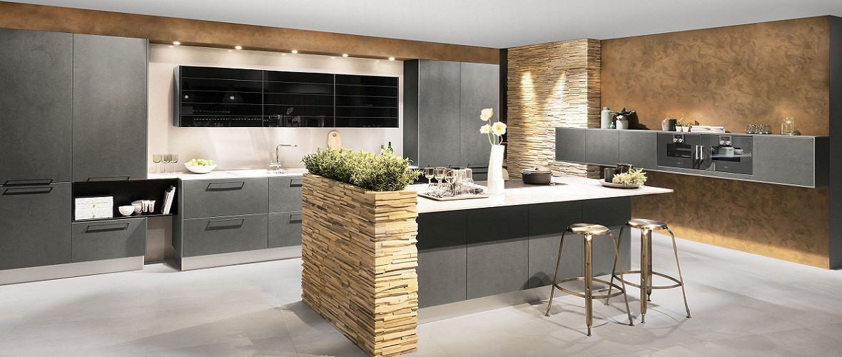 Modern kitchen with sleek grey cabinets and a central island with stone accents.