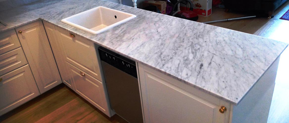 Carrara marble worktop with integrated sink in a modern kitchen