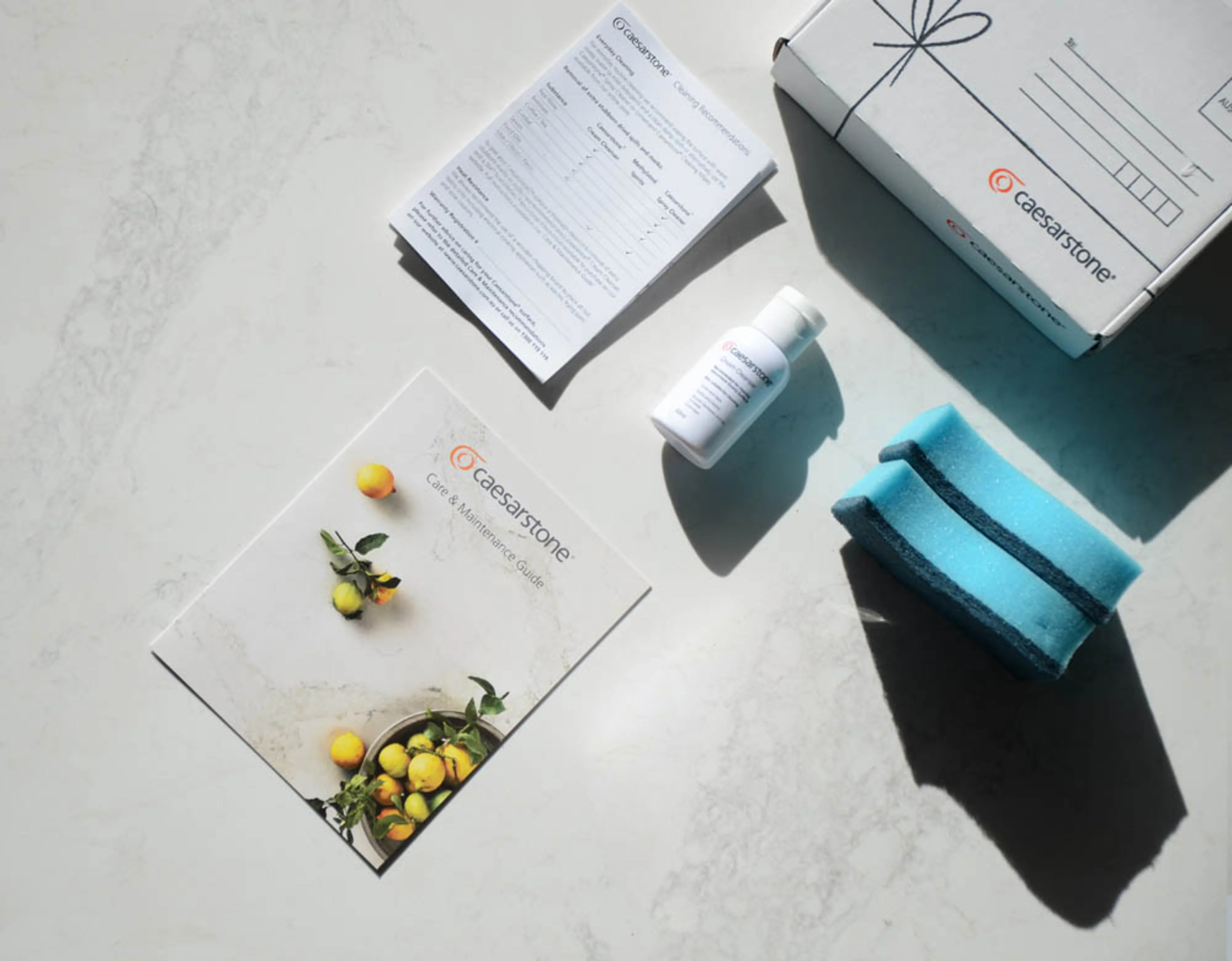 A series of documents about Caesarstone on a white worktop.