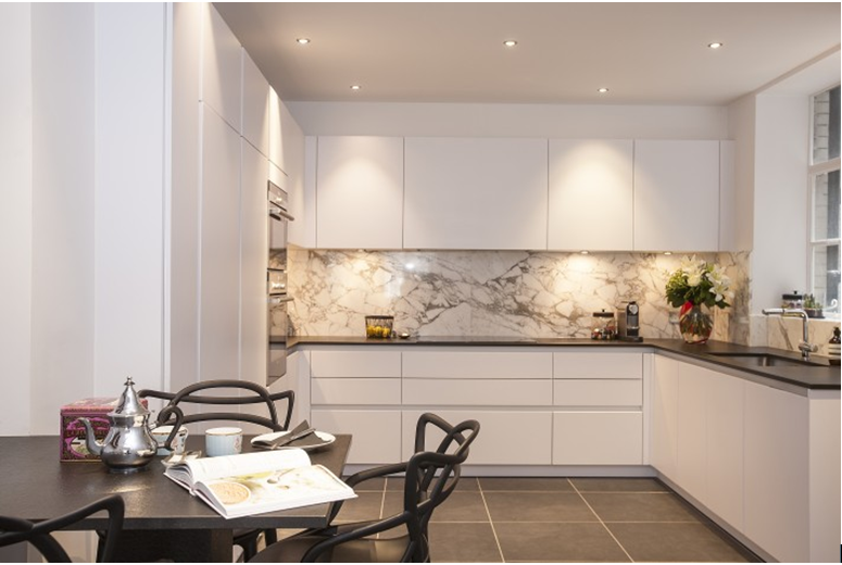 Modern kitchen with marble splashback and dark worktop